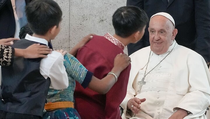 Pope Francis is welcomed by dancing children as he arrives at Singapore airport on September 11, 2024. Photo: Gregorio Borgia/AP