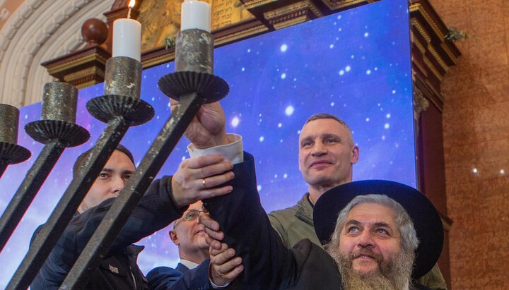 Lighting the menorah candle. Photo: Facebook of the Chief Rabbi